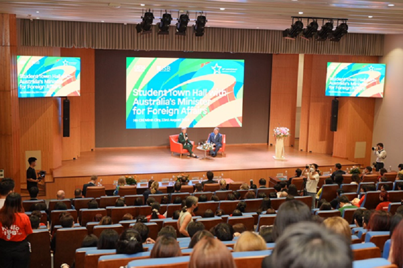 A group of people sitting on a stageDescription automatically generated