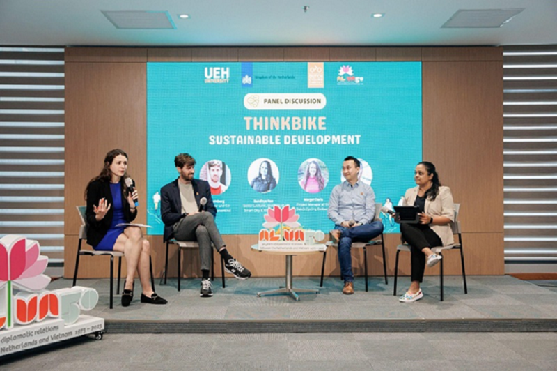 A group of people sitting on a stageDescription automatically generated